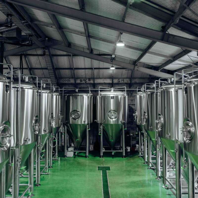 Large Stainless Conical Fermenters and brite tanks installed in a brewery
